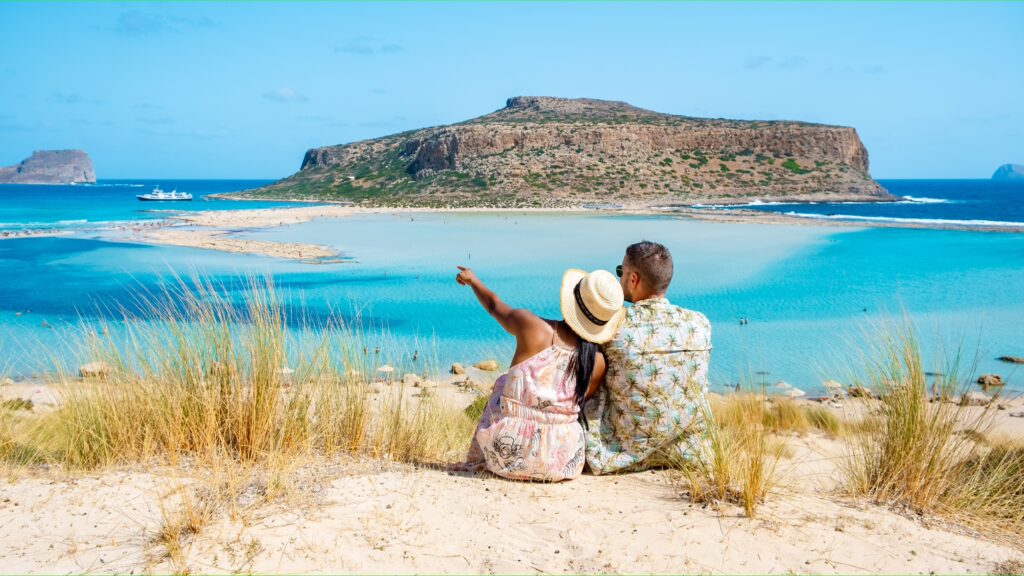 Crète Grèce, lagune de Balos, île de Crète, Grèce. Des touristes se détendent dans l'océan cristallin de la plage de Balos. Un couple d'un homme et une femme visitent la plage lors de vacances en Grèce par une journée ensoleillée.